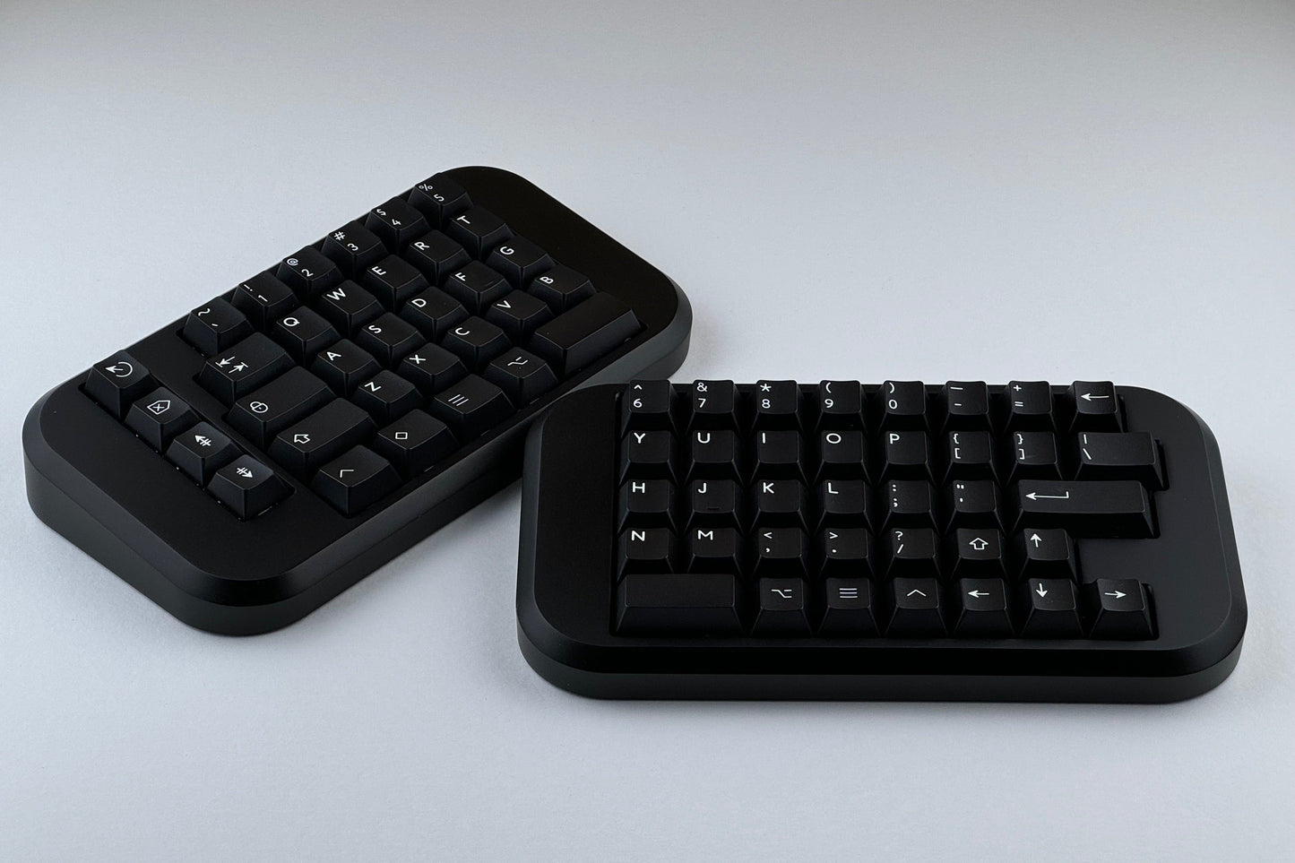 Black Hall effect split keyboard with black keycaps, ortholinear layout for gaming