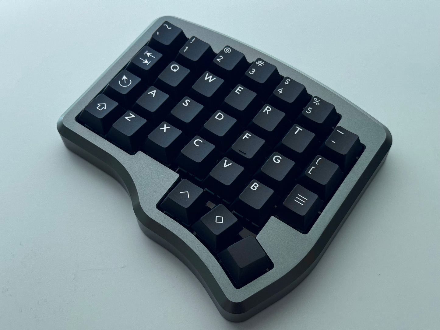 Top view of grey Hall effect split keyboard with 4x6 column staggered keys and 3 thumb keys black keycaps