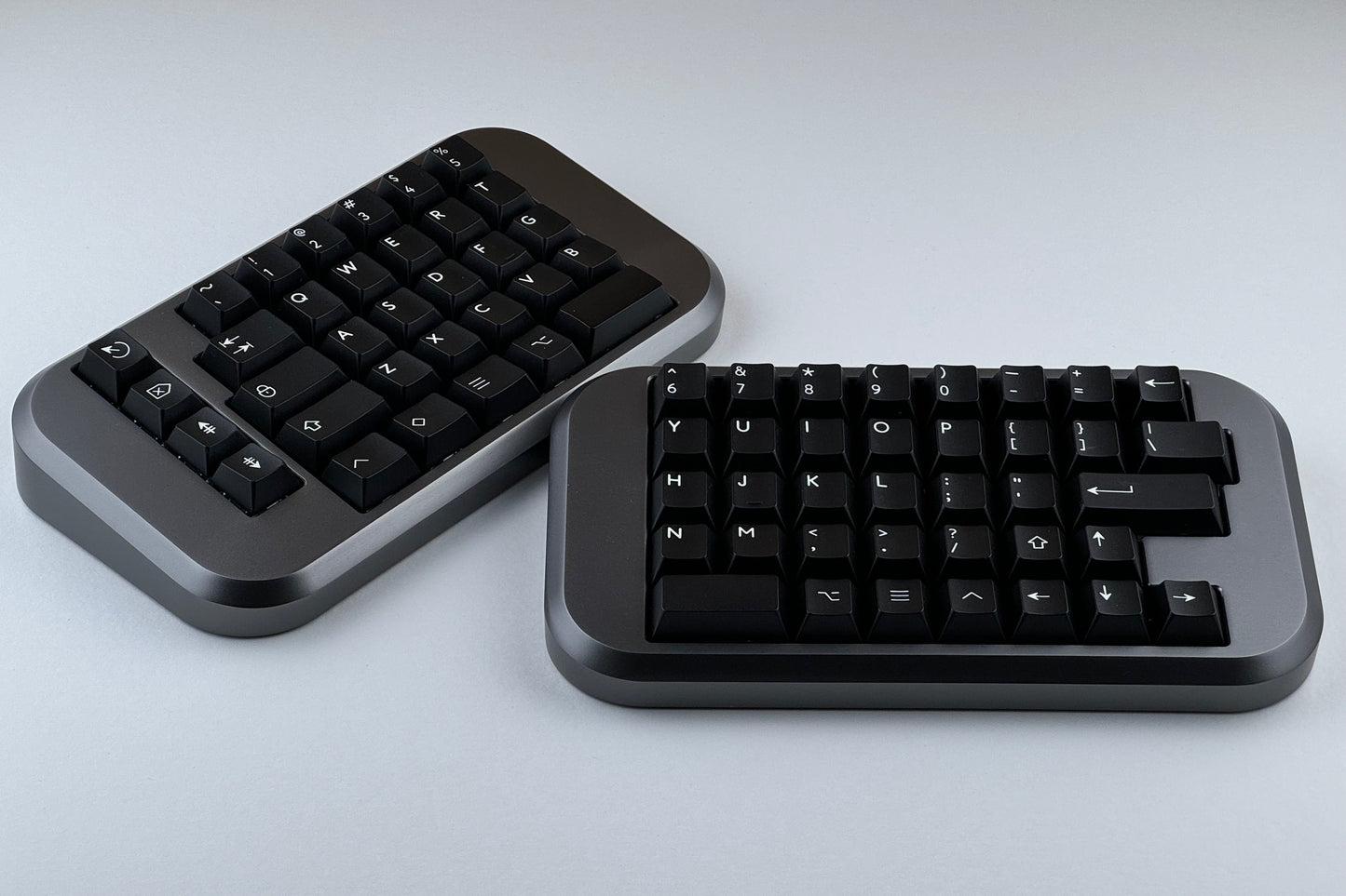 Grey Hall effect split keyboard with black keycaps, ortholinear layout for gaming
