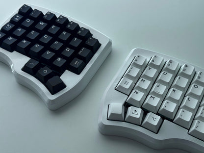 White Hall effect split keyboard with 4x6 column staggered keys and 3 thumb keys black and white keycaps