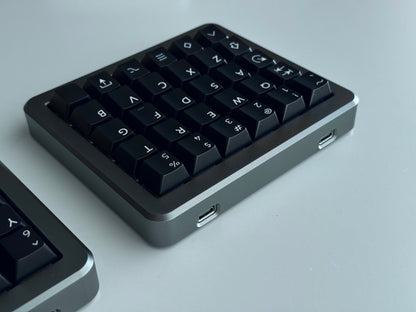 Back view of grey Hall effect split keyboard 5x6 ortholinear with black keycaps