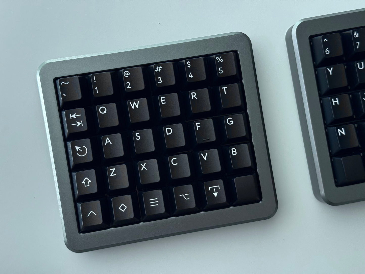 Top view of grey Hall effect split keyboard 5x6 ortholinear with black keycaps