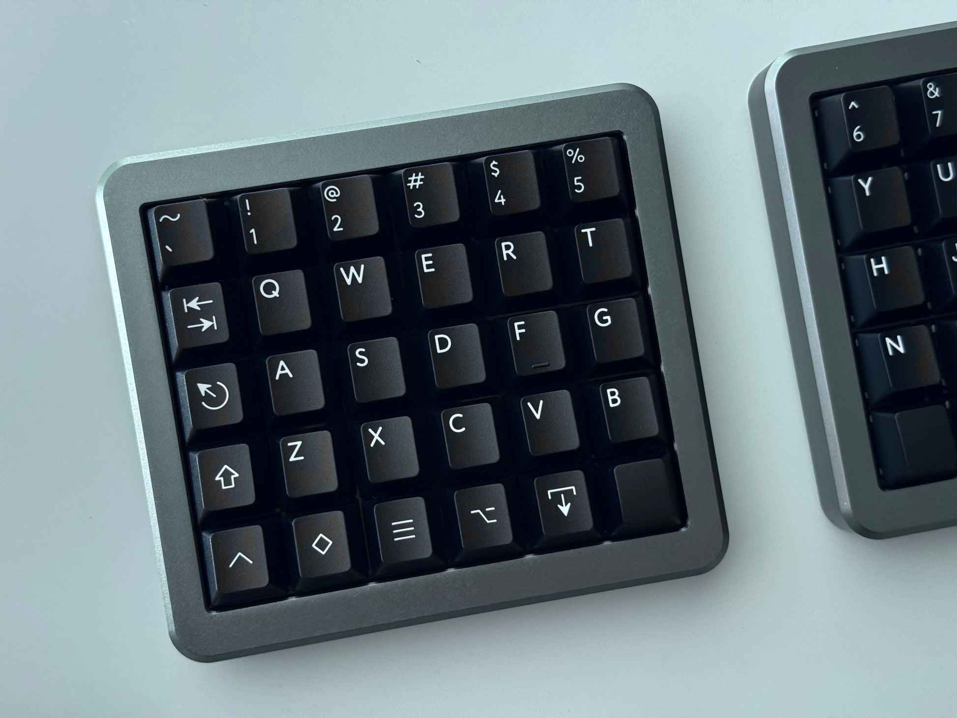Top view of grey Hall effect split keyboard 5x6 ortholinear with black keycaps